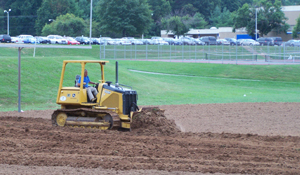 Tractor pushing dirt.